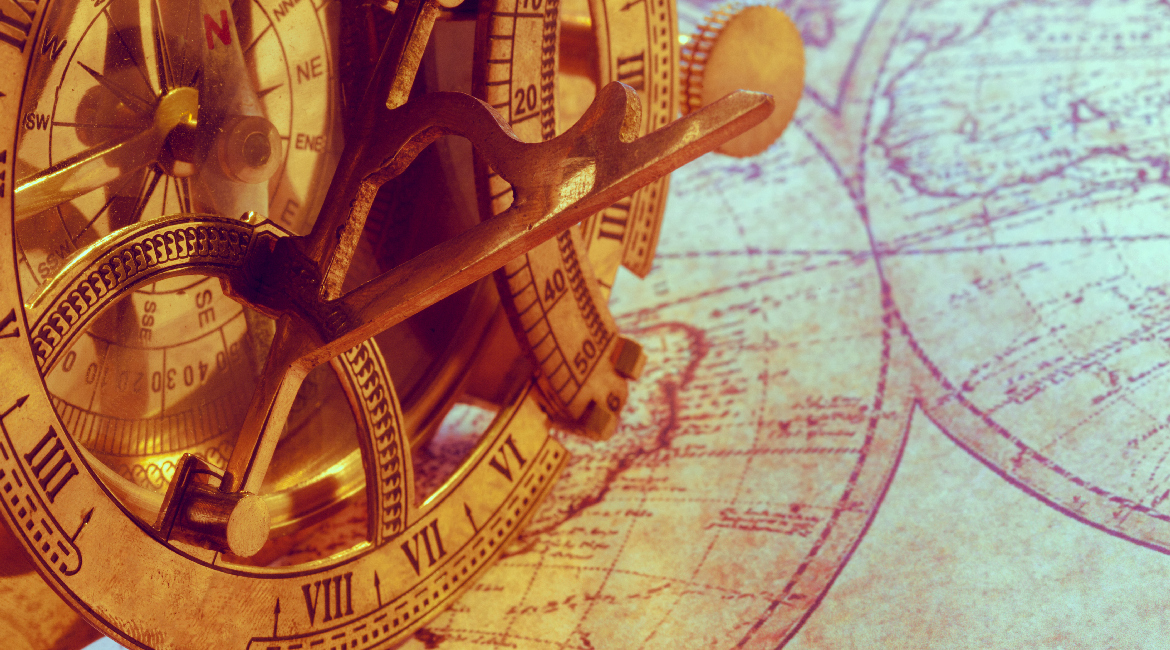 Old compass over ancient map